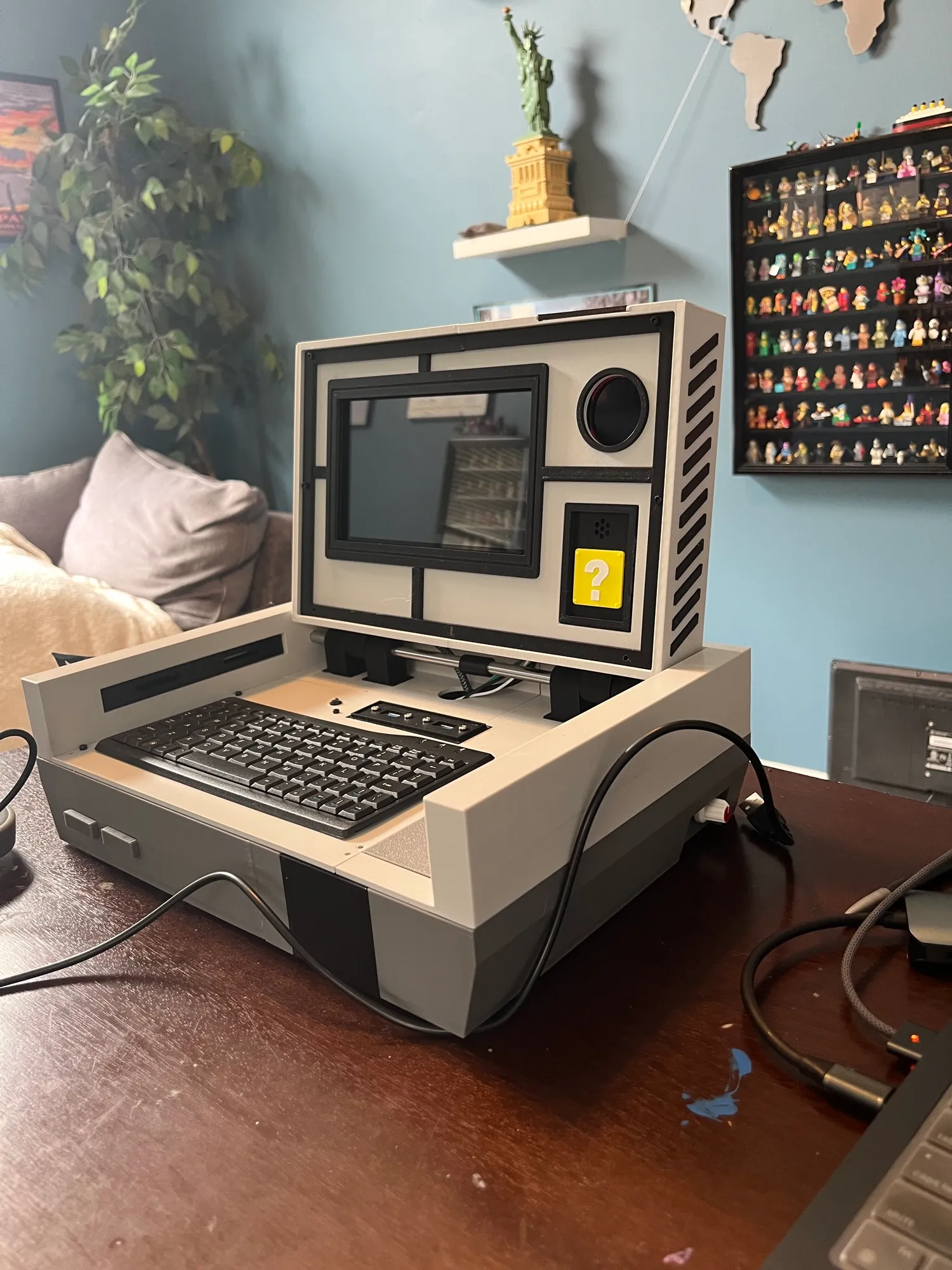 Overview of the Pi-tendo: a 3D printed case styled like an original Nintendo, with its controllers and keyboard.