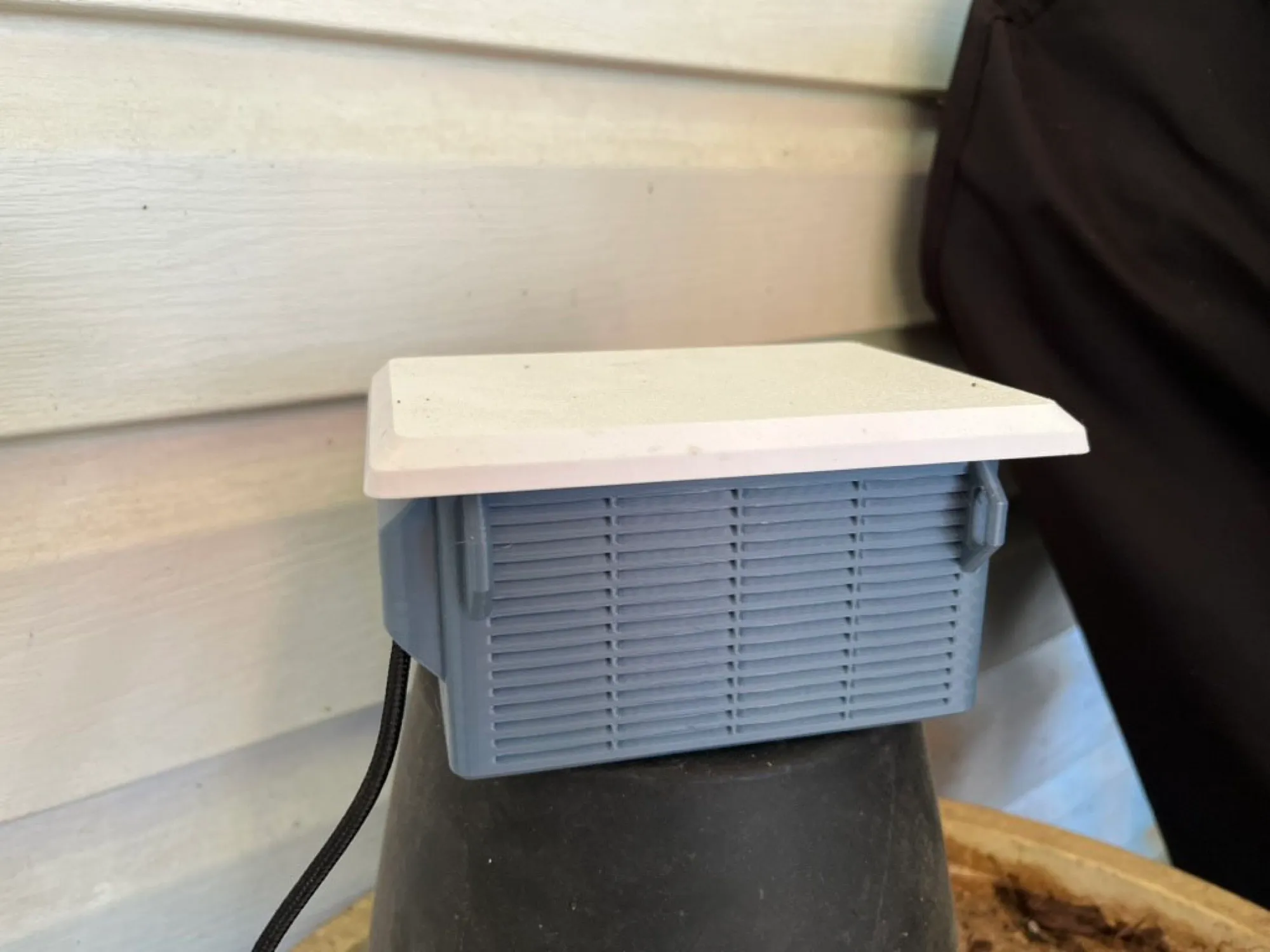 The weather station enclosure mounted beside the exterior outlet