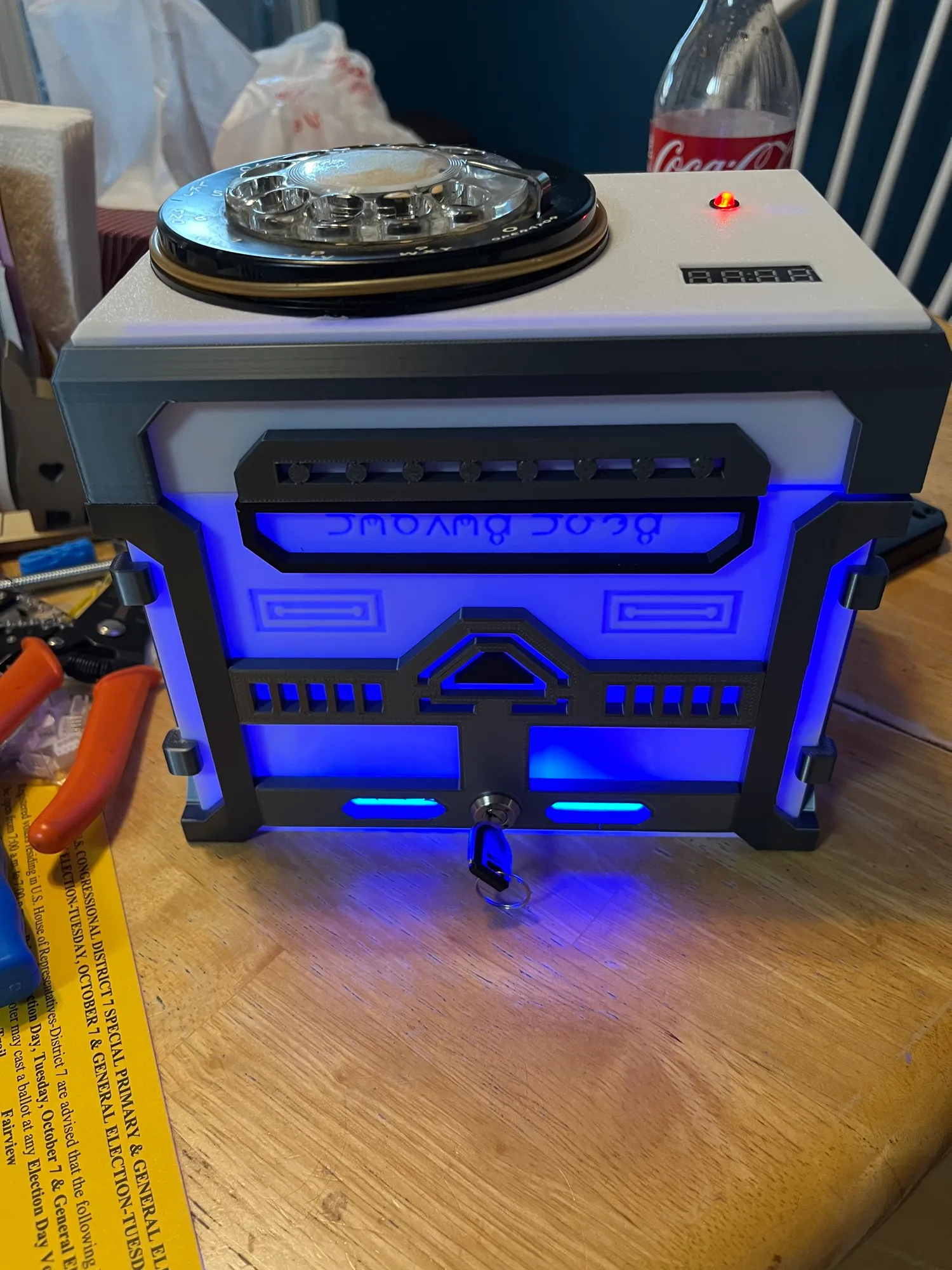 The rotary dial safe switched on, with its blue glow lights and status LED lit.