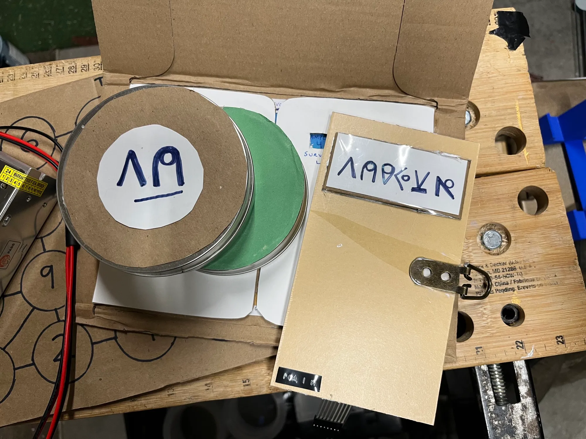 A metal canister artifact with an alien symbol on top and a coloured base, ready to be scanned