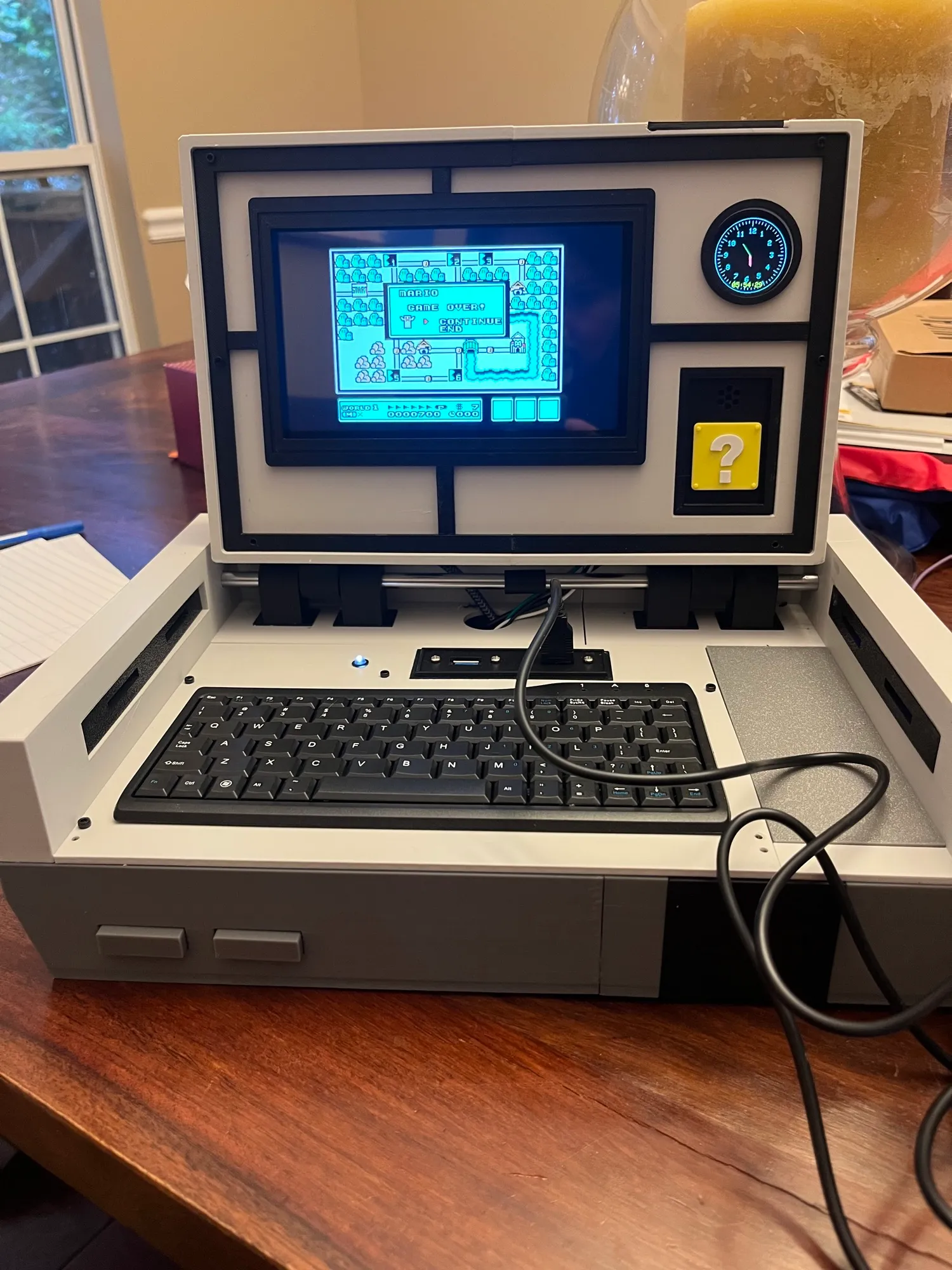 The Pi-tendo opened like a laptop, with Super Mario Bros. 3 on the screen.