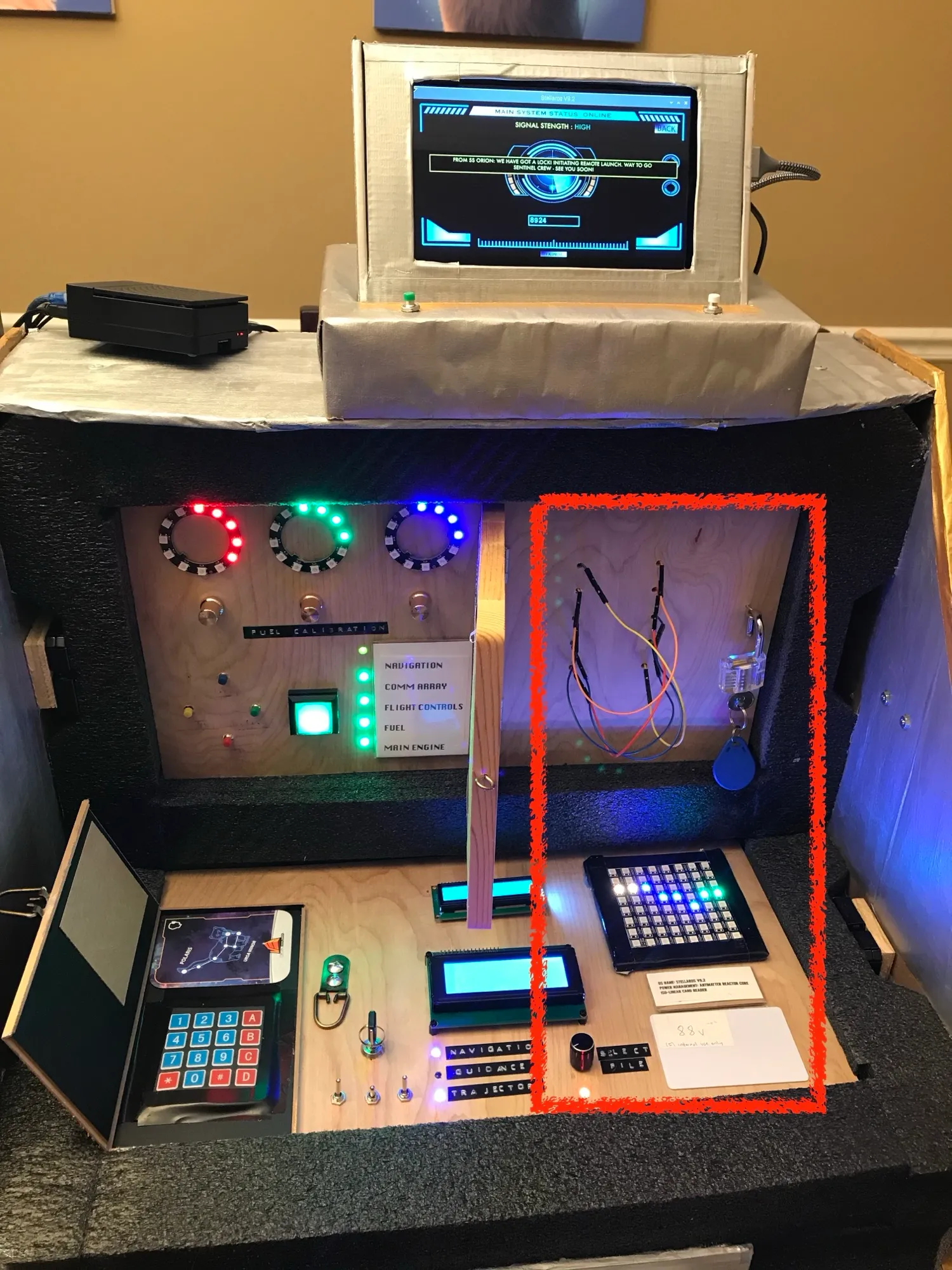 The control panel wiring console with coloured wire posts on either side, the NeoPixel matrix, and the green status LEDs